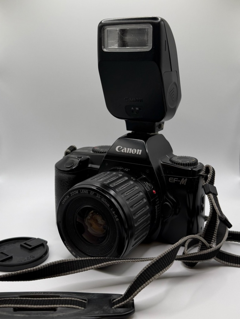 Canon Black DSLR with Zoom Lens and Hotshoe Flash